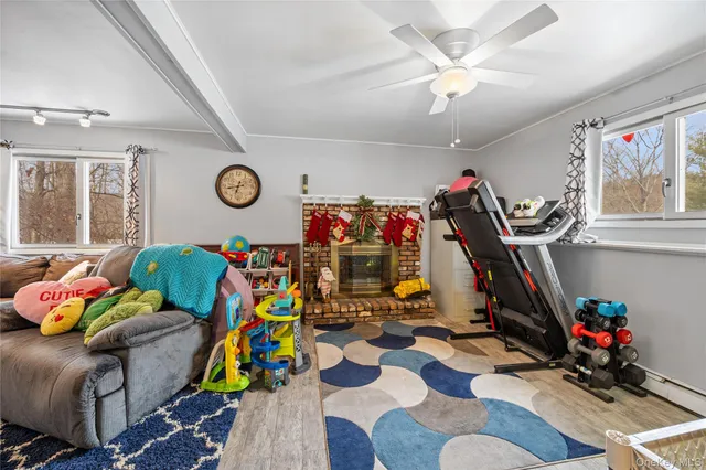 a bedroom with furniture and a fan