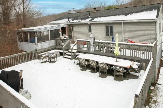 a view of a house with a wooden bench