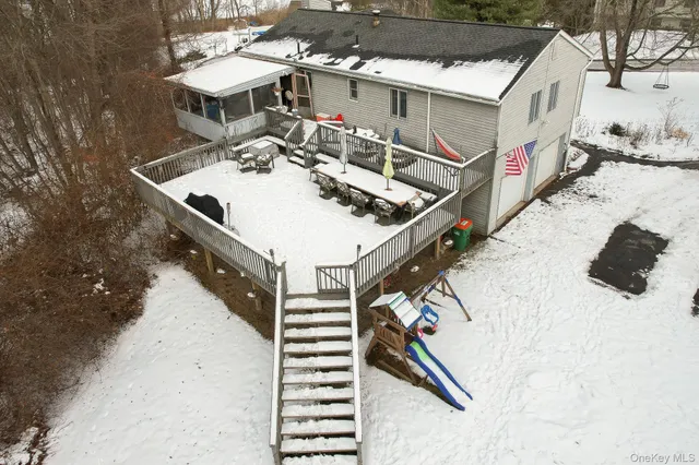 a view of a house with pool and chairs
