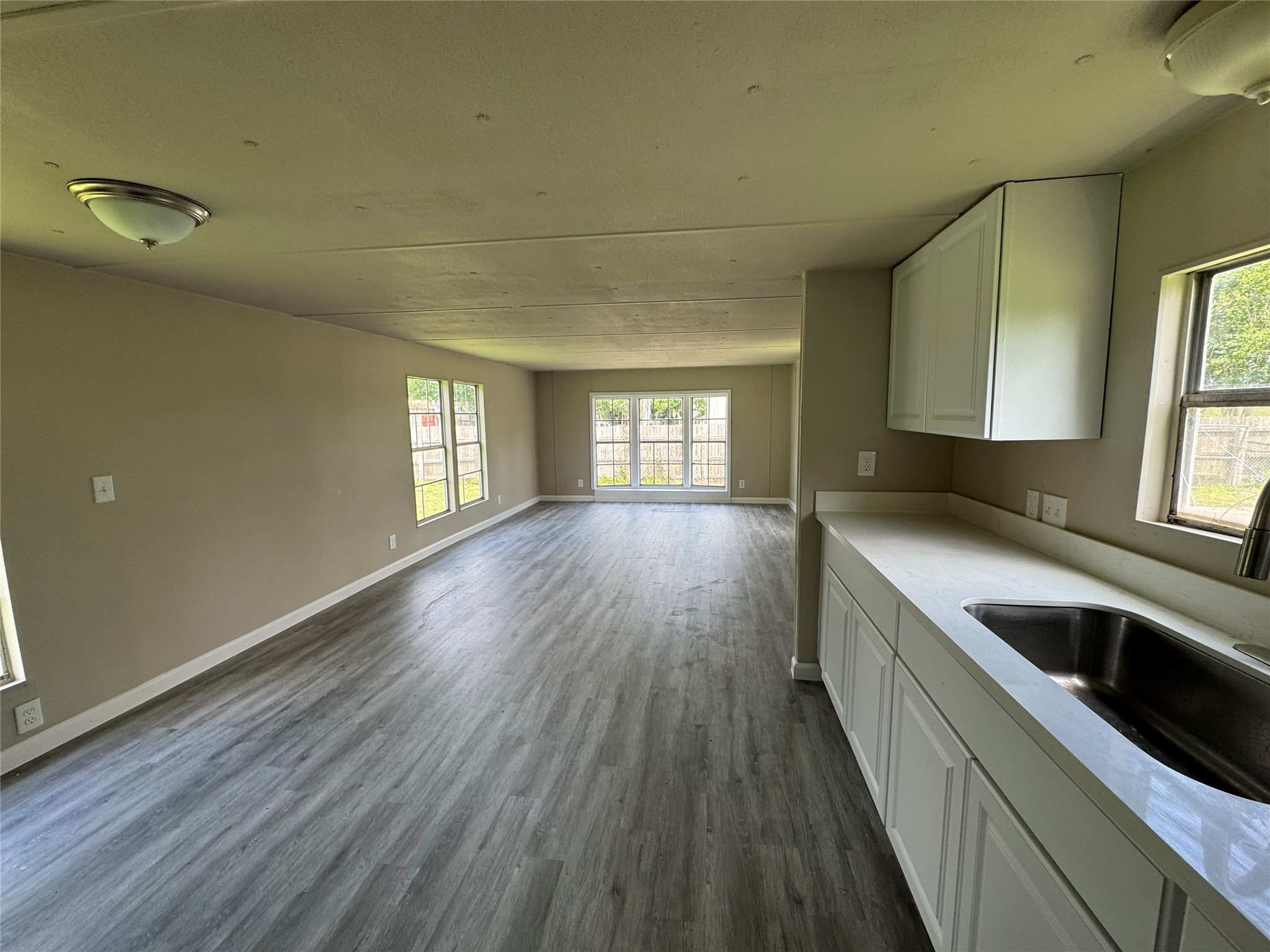 6226 County Road 48 Rosharon, TX 77583 - Photo 2 of 11 a kitchen with granite countertop white cabinets and wooden floor