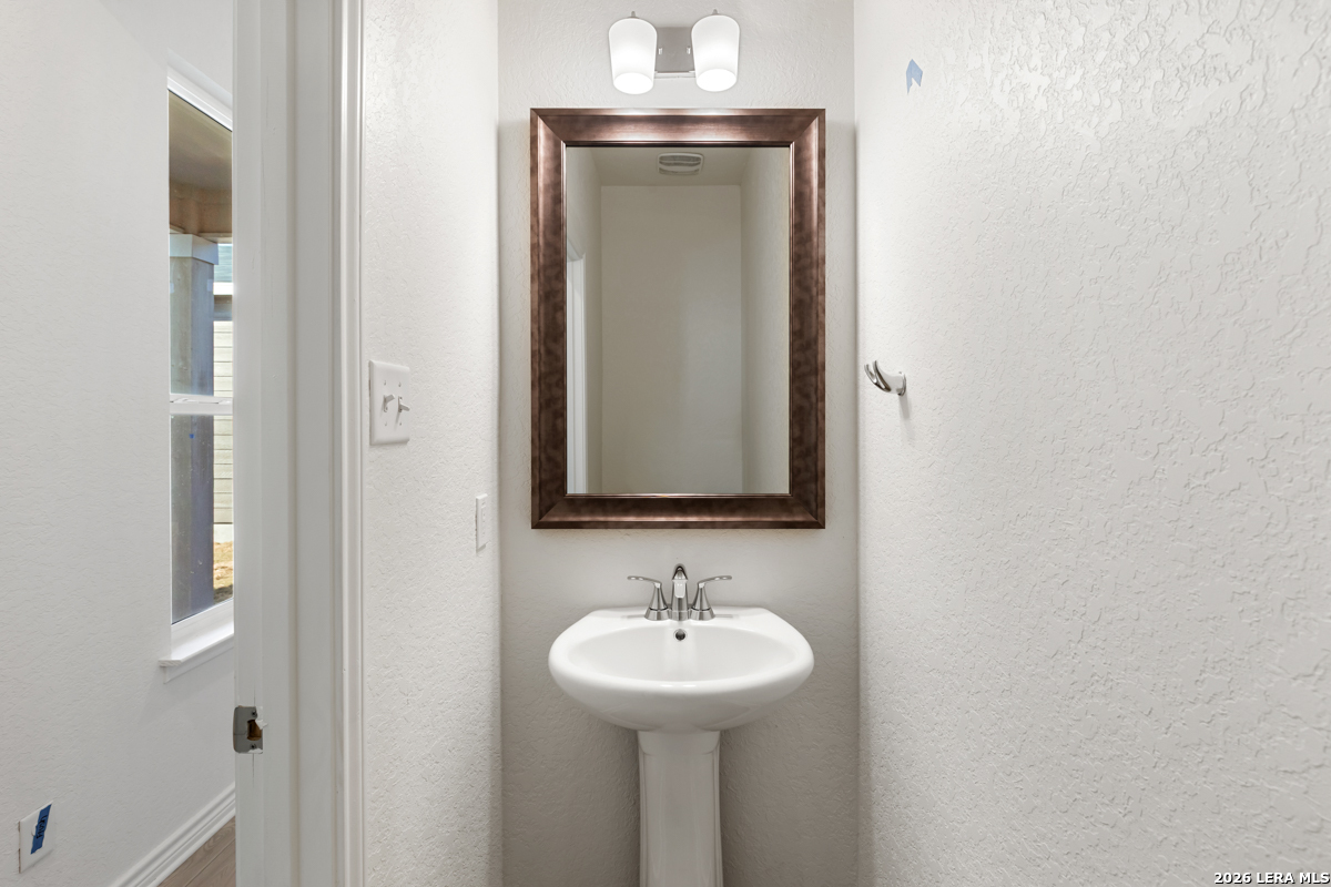 10045 Jagger Avenue Converse, TX 78109 - Photo 16 of 28 a bathroom with a sink and a mirror