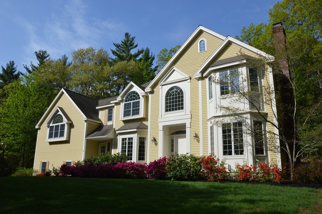 175 Robinson Road Boxborough, MA 01719 - Photo 1 of 30 a front view of a house with a yard and trees