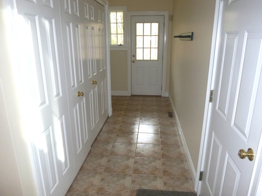 175 Robinson Road Boxborough, MA 01719 - Photo 14 of 30 a view of a hallway with wooden floor and stairs