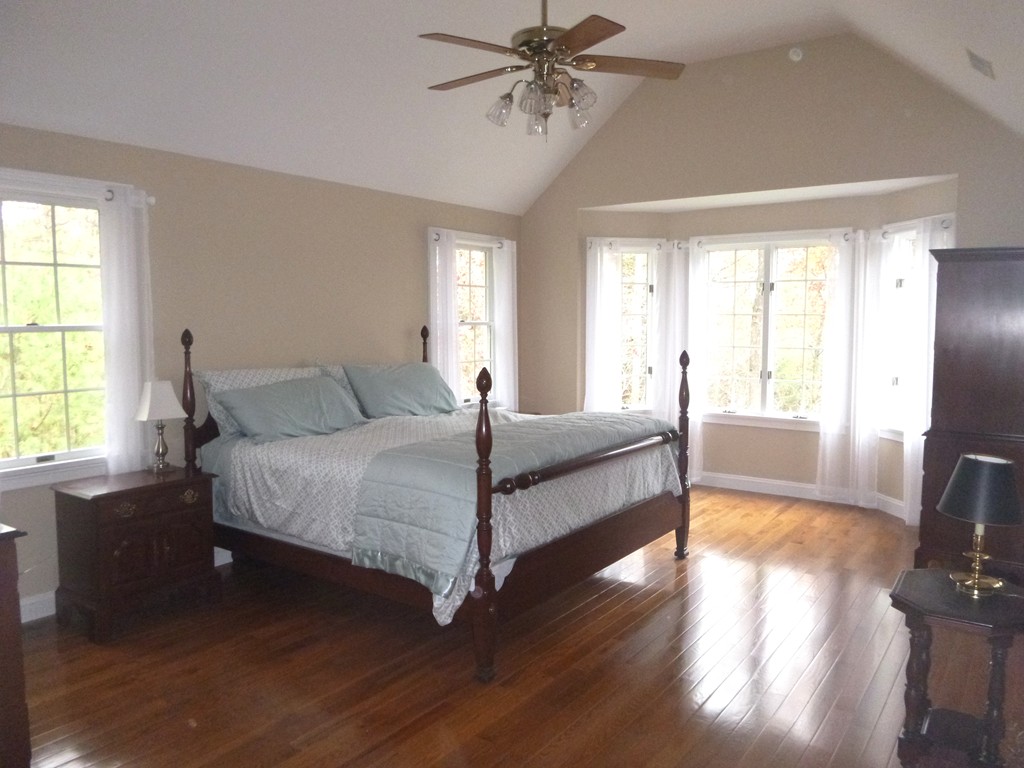 175 Robinson Road Boxborough, MA 01719 - Photo 16 of 30 a bedroom with a bed and wooden floor