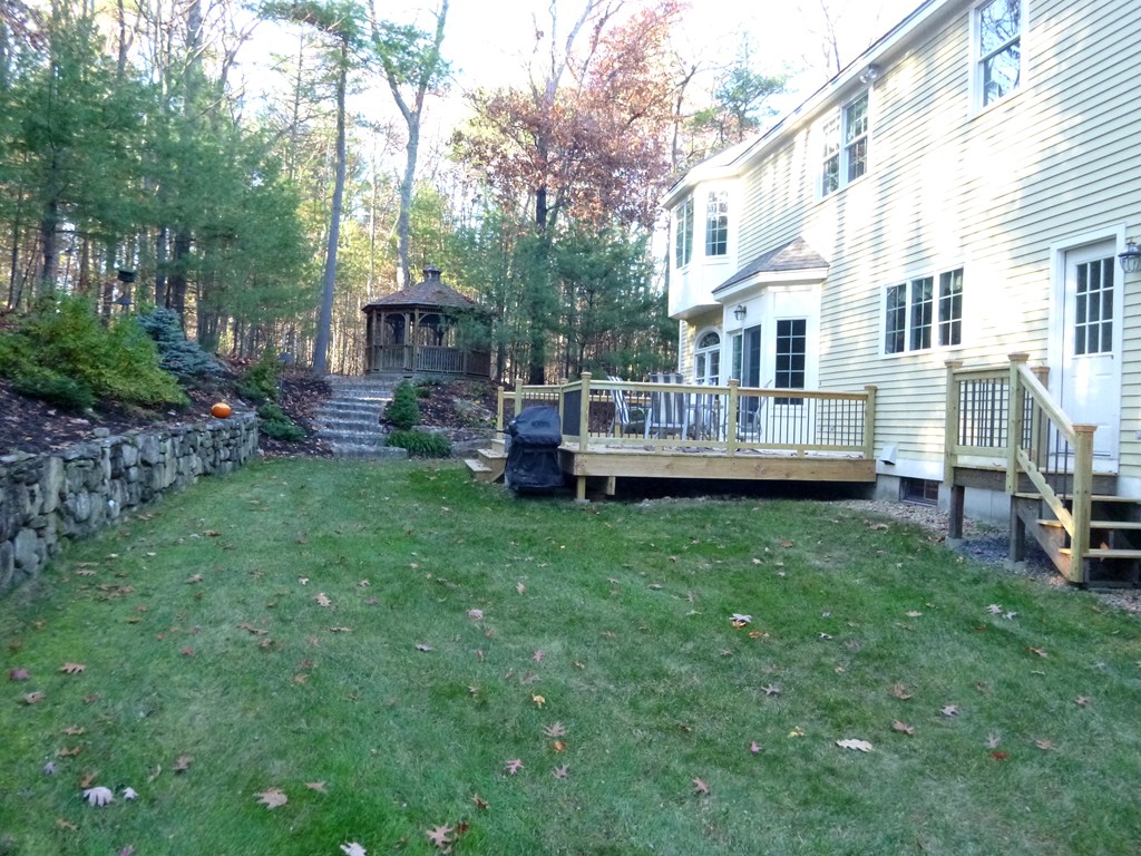 175 Robinson Road Boxborough, MA 01719 - Photo 25 of 30 a view of a house with backyard and sitting area