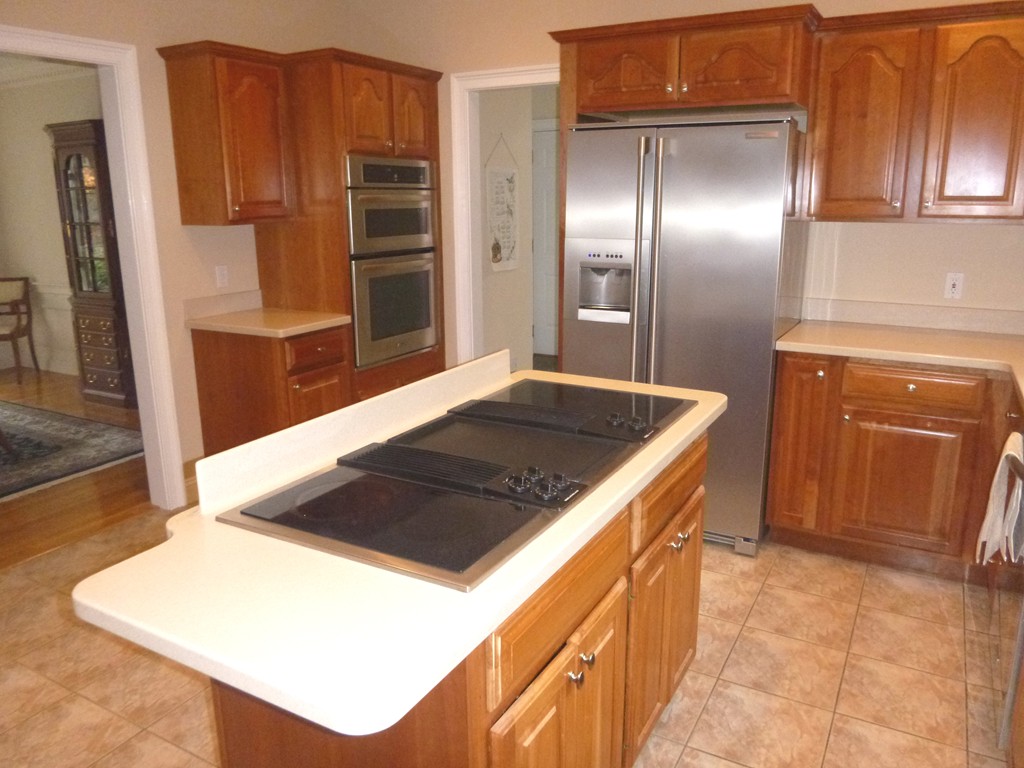 175 Robinson Road Boxborough, MA 01719 - Photo 7 of 30 a kitchen with a refrigerator and a sink