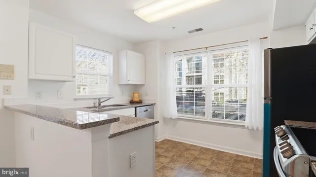 a kitchen with a stove a sink and a microwave