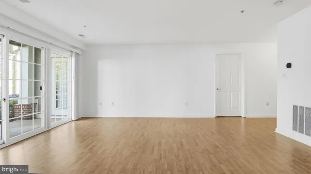 a bathroom with a granite countertop bathtub shower sink vanity and toilet