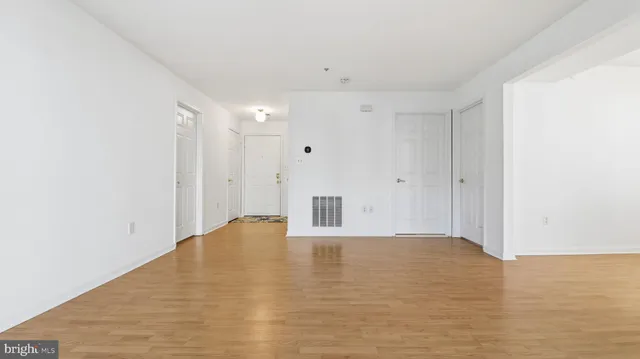 a view of walk in closet with empty racks