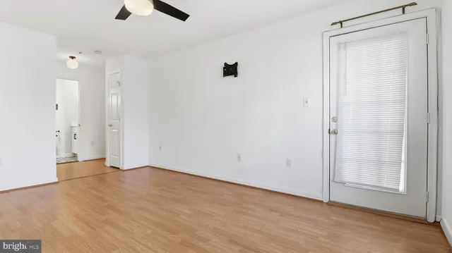 wooden floor in an empty room with a window