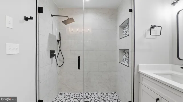 a front view of a building with outdoor space and seating area