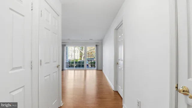 a view of empty room with wooden floor and fireplace