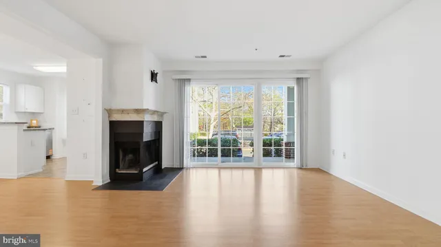 a view of a kitchen with a sink dishwasher and wooden floor