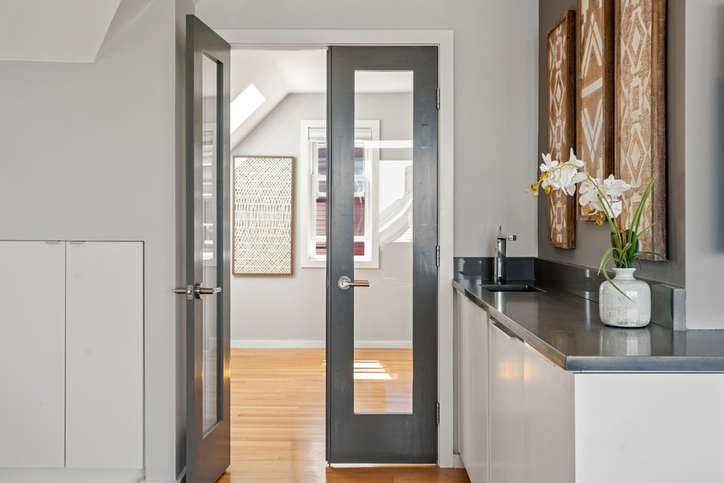 19 Salcombe Street Boston, MA 02125 - Photo 12 of 40 a bathroom with a granite countertop sink a mirror and a shower