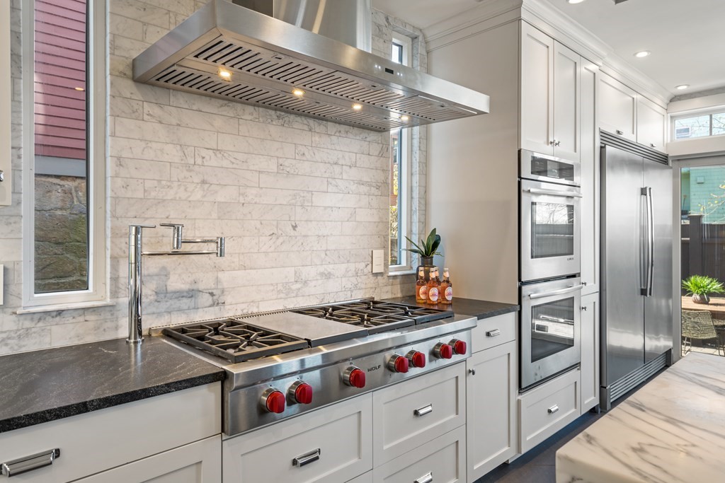 19 Salcombe Street Boston, MA 02125 - Photo 19 of 40 a kitchen with stainless steel appliances granite countertop a stove and a refrigerator