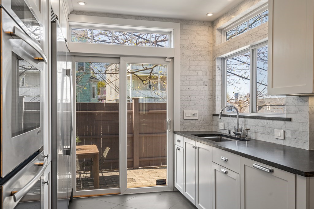 19 Salcombe Street Boston, MA 02125 - Photo 20 of 40 a kitchen with stainless steel appliances granite countertop a refrigerator and a sink