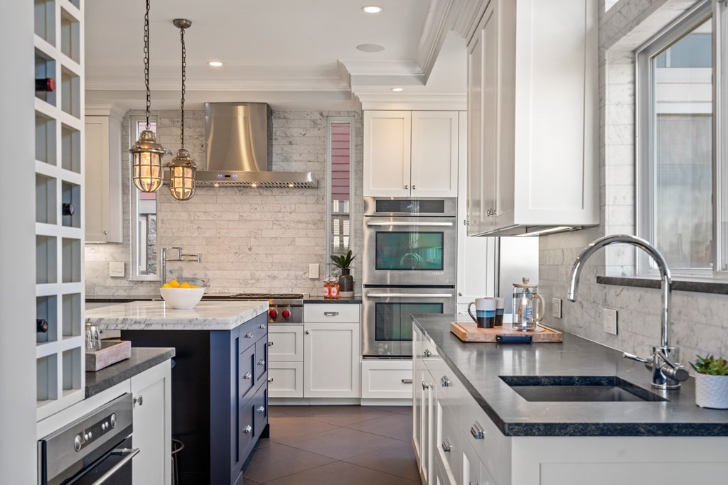 19 Salcombe Street Boston, MA 02125 - Photo 21 of 40 a kitchen with stainless steel appliances granite countertop a sink stove and cabinets