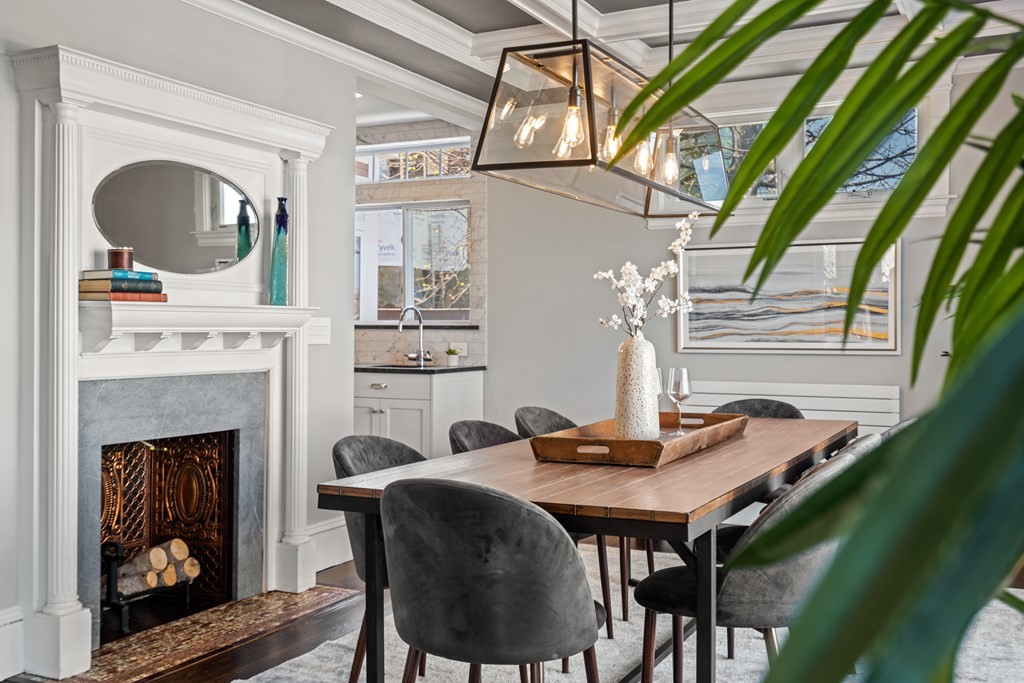 19 Salcombe Street Boston, MA 02125 - Photo 24 of 40 a dining room with a fireplace and a floor to ceiling window