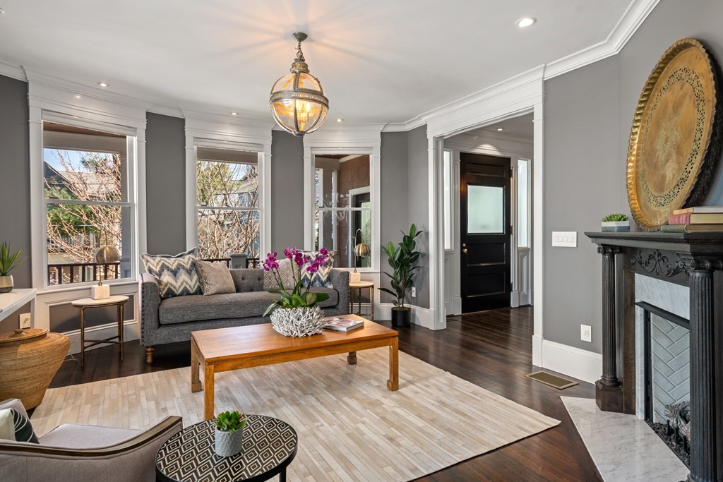 19 Salcombe Street Boston, MA 02125 - Photo 27 of 40 a living room with furniture a fireplace and a chandelier