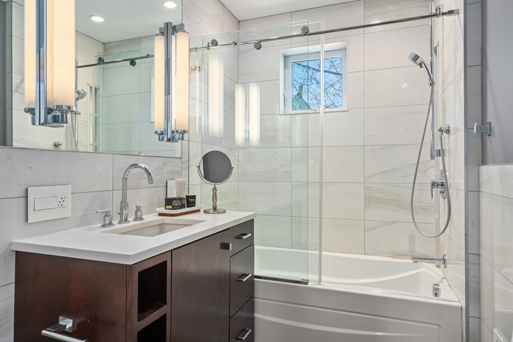 19 Salcombe Street Boston, MA 02125 - Photo 33 of 40 a bathroom with a sink and a mirror