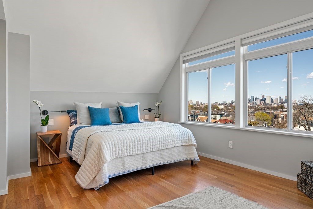 19 Salcombe Street Boston, MA 02125 - Photo 9 of 40 a bedroom with a bed painting on wall and a large window
