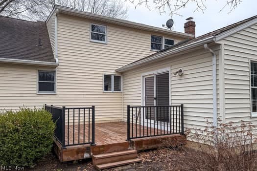4293 Good Road Seville, OH 44273 - Photo 5 of 35 Back of house featuring a wooden deck and a chimney