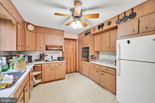 a kitchen with cabinets stainless steel appliances and a window