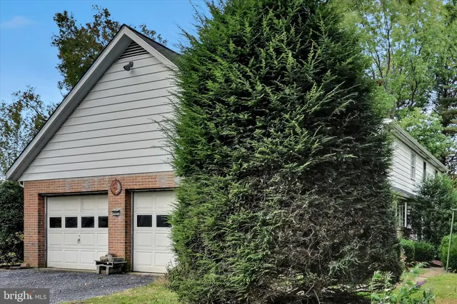 a view of white house with a sink and plants