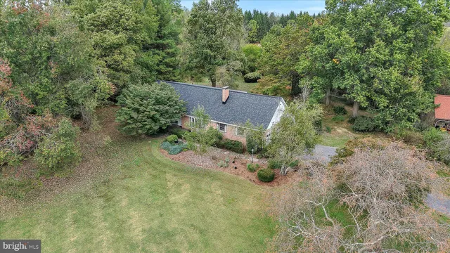 an aerial view of a house with a yard