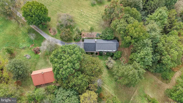an aerial view of a house with a yard