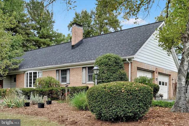 a front view of a house with a yard and potted plants
