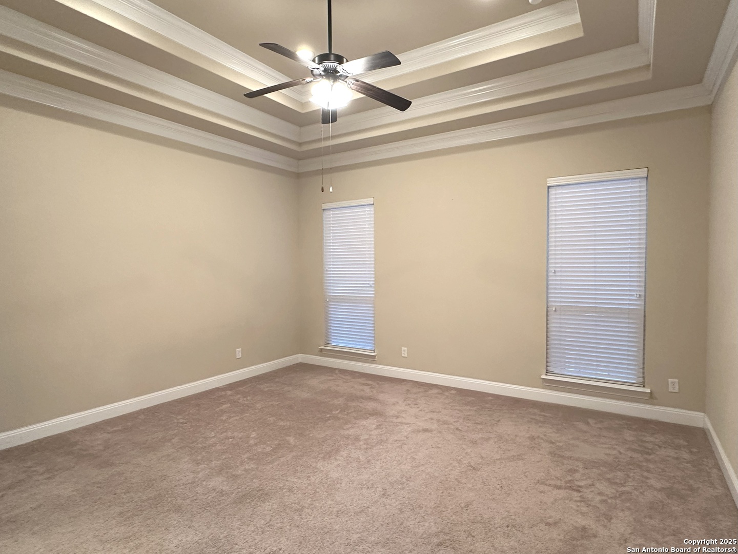 24507 Chianti Way San Antonio, TX 78260 - Photo 11 of 26 an empty room with a chandelier fan and windows