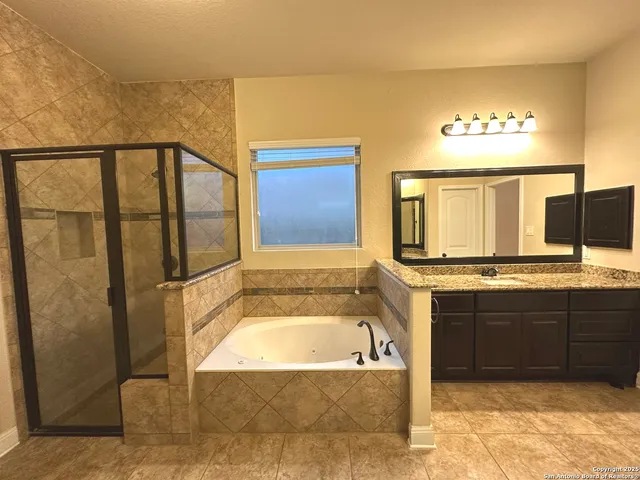a bathroom with a tub and sink