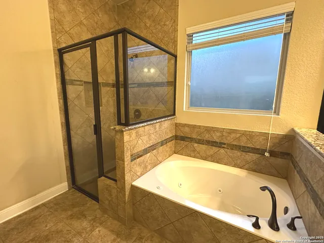 a bathroom with a tub and shower