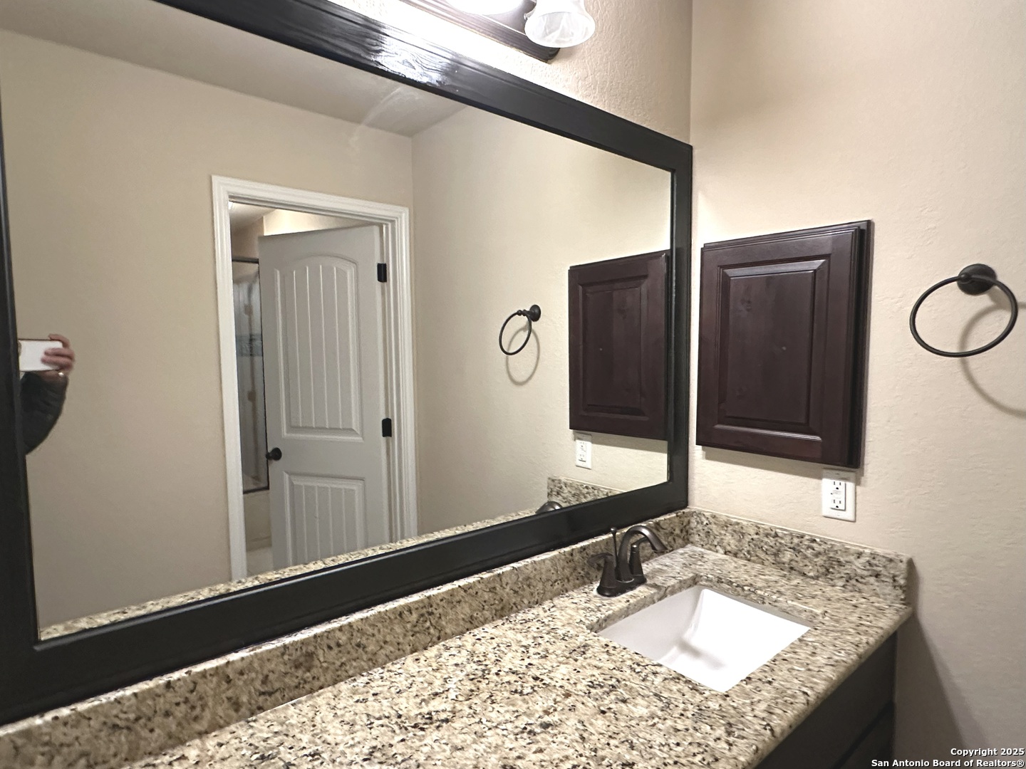 24507 Chianti Way San Antonio, TX 78260 - Photo 20 of 26 a bathroom with a granite countertop sink and a mirror