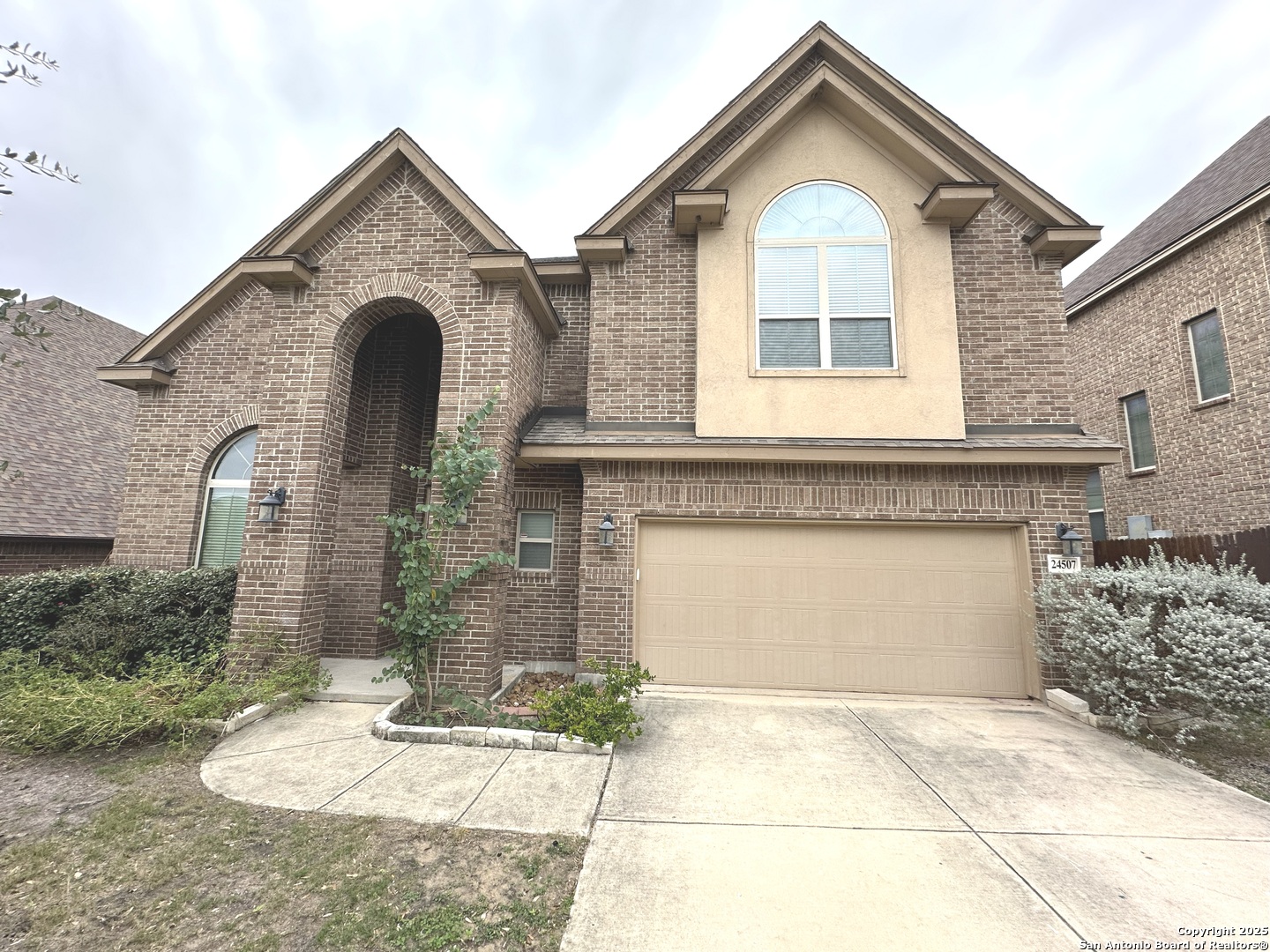 24507 Chianti Way San Antonio, TX 78260 - Photo 2 of 26 a front view of a house with a yard