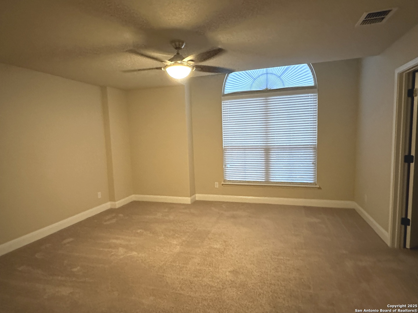24507 Chianti Way San Antonio, TX 78260 - Photo 21 of 26 an empty room with windows and fan