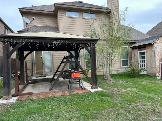 a view of house with backyard and deck