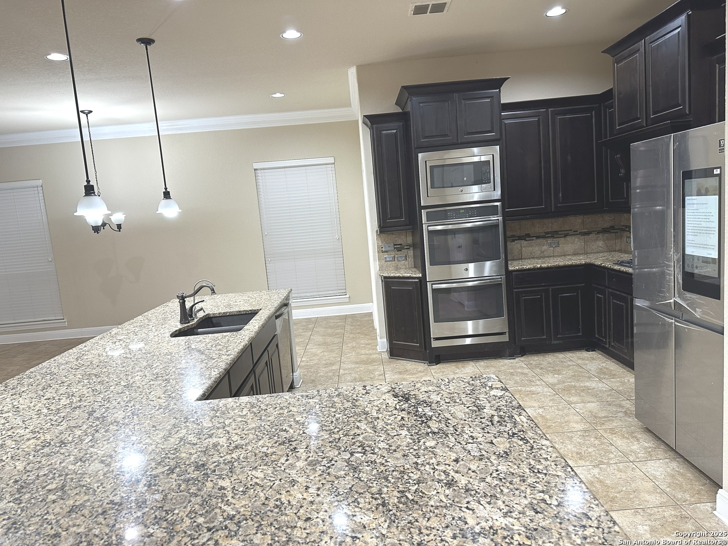 24507 Chianti Way San Antonio, TX 78260 - Photo 4 of 26 a kitchen with stainless steel appliances granite countertop a sink refrigerator and microwave