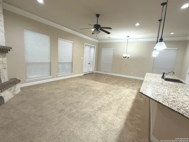 a view of a kitchen with a sink and a mirror