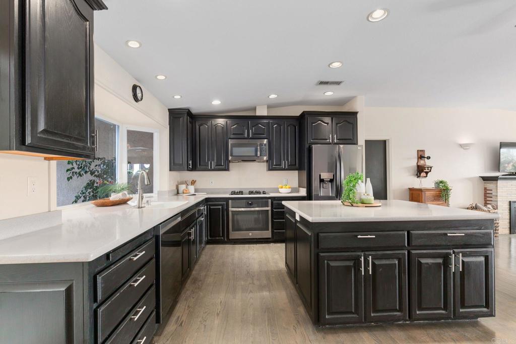 3326 Monroe Street Carlsbad, CA 92008 - Photo 12 of 63 a kitchen with stainless steel appliances granite countertop a sink a stove and a refrigerator