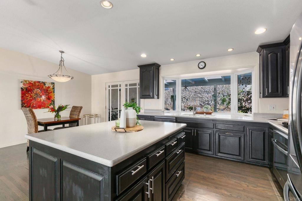 3326 Monroe Street Carlsbad, CA 92008 - Photo 13 of 63 a kitchen with stainless steel appliances granite countertop a sink a stove and a refrigerator
