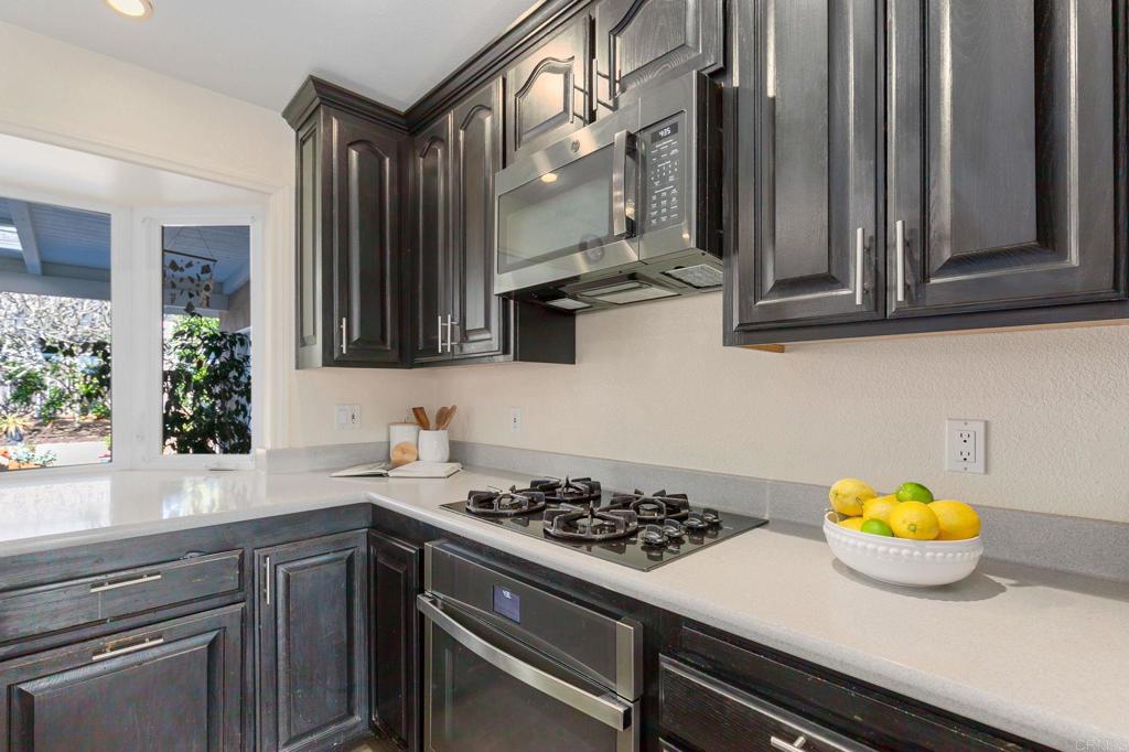 3326 Monroe Street Carlsbad, CA 92008 - Photo 16 of 63 a kitchen with a sink a stove and a window