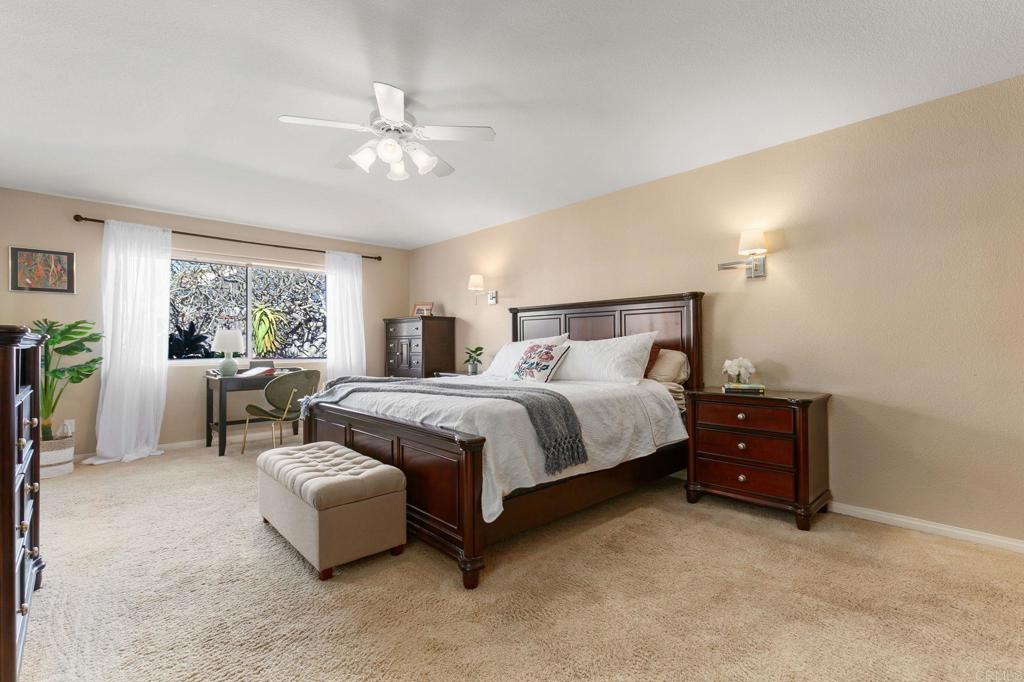 3326 Monroe Street Carlsbad, CA 92008 - Photo 21 of 63 a bedroom with a bed and a chandelier