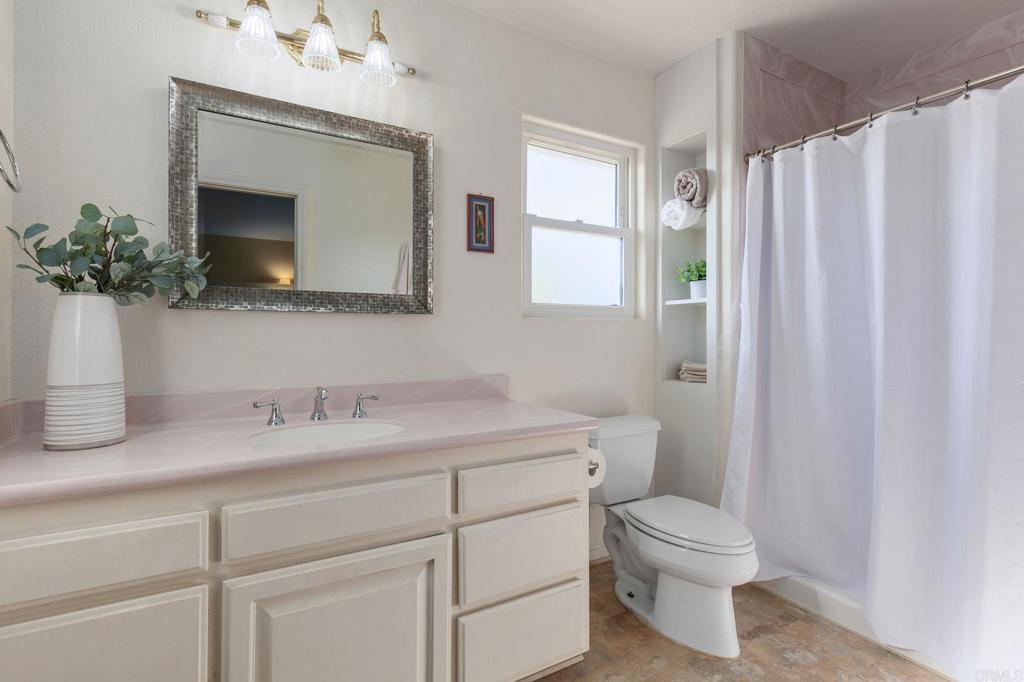3326 Monroe Street Carlsbad, CA 92008 - Photo 24 of 63 a bathroom with a toilet sink and mirror