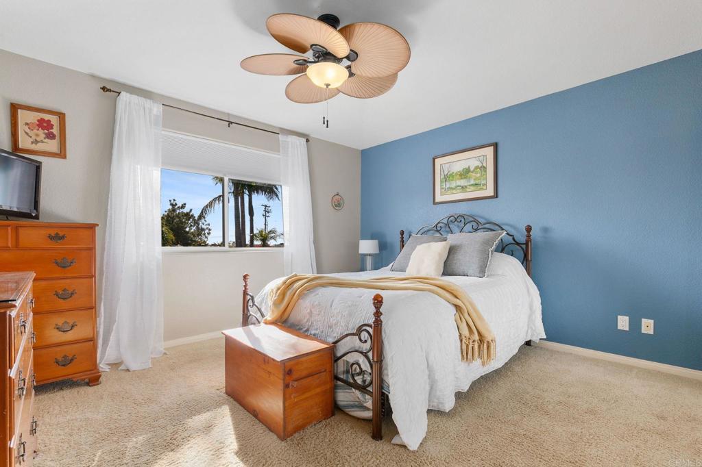 3326 Monroe Street Carlsbad, CA 92008 - Photo 26 of 63 a bedroom with a bed and a chandelier