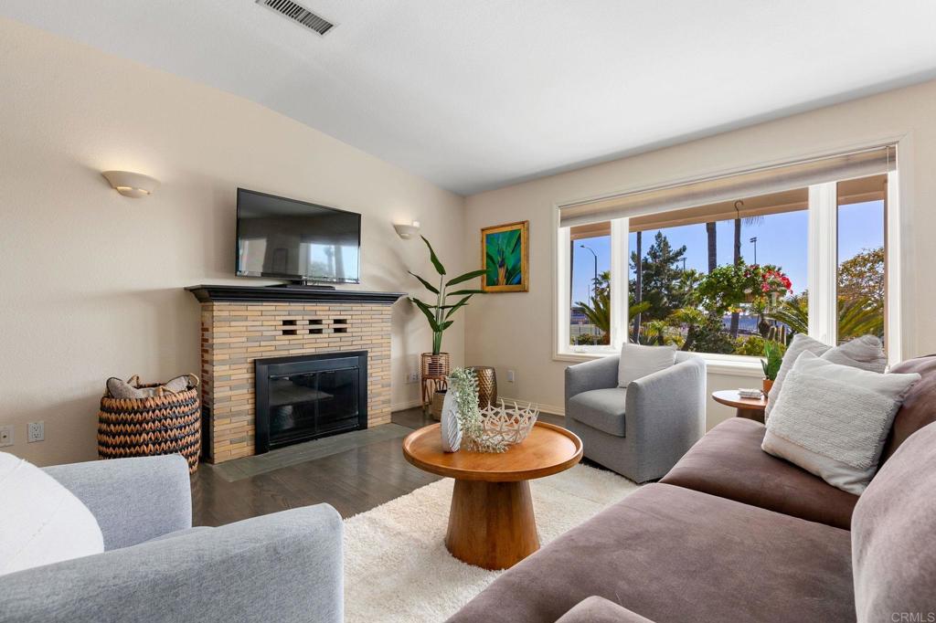 3326 Monroe Street Carlsbad, CA 92008 - Photo 6 of 63 a living room with furniture a fireplace and a flat screen tv