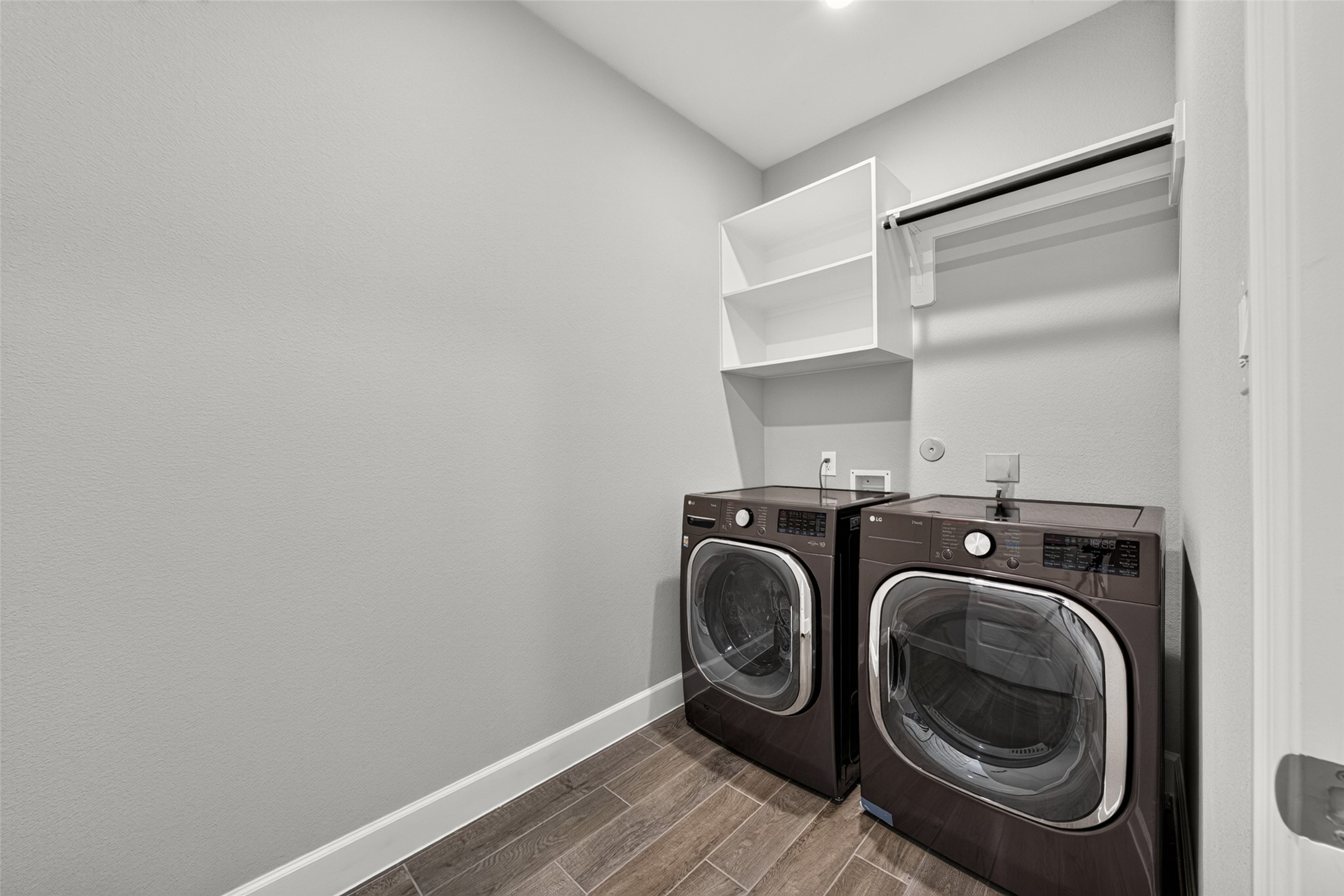 4207 Ana Ridge Lane Fulshear, TX 77441 - Photo 29 of 37 Dedicated laundry room equipped with stylish front-load appliances and overhead cabinetry, designed to make everyday family chores quick and organized!