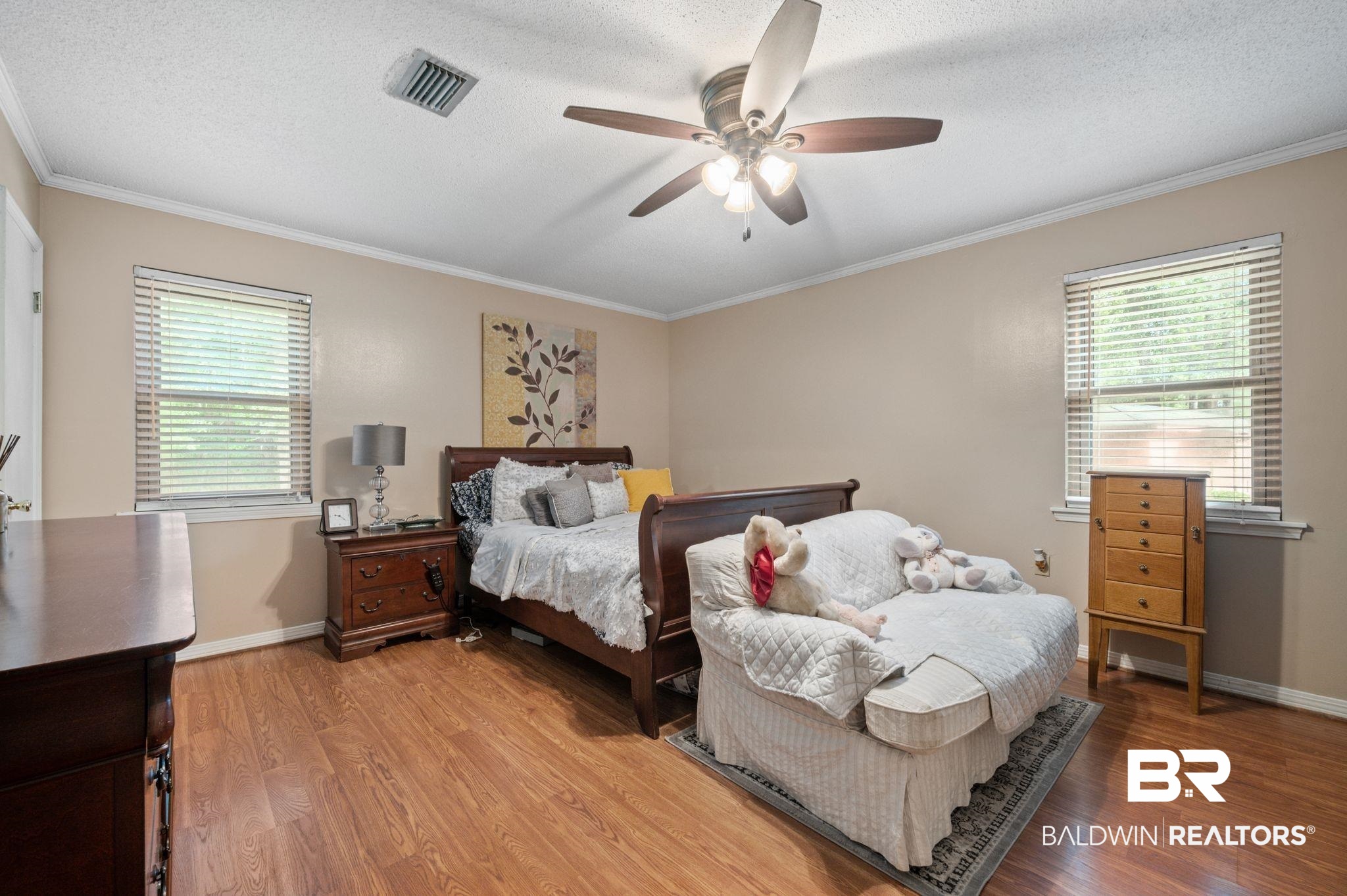 4566 McCrary Road, Unit A Semmes, AL 36575 - Photo 19 of 28 Bedroom featuring ceiling fan, crown molding, wood-type flooring, and a textured ceiling