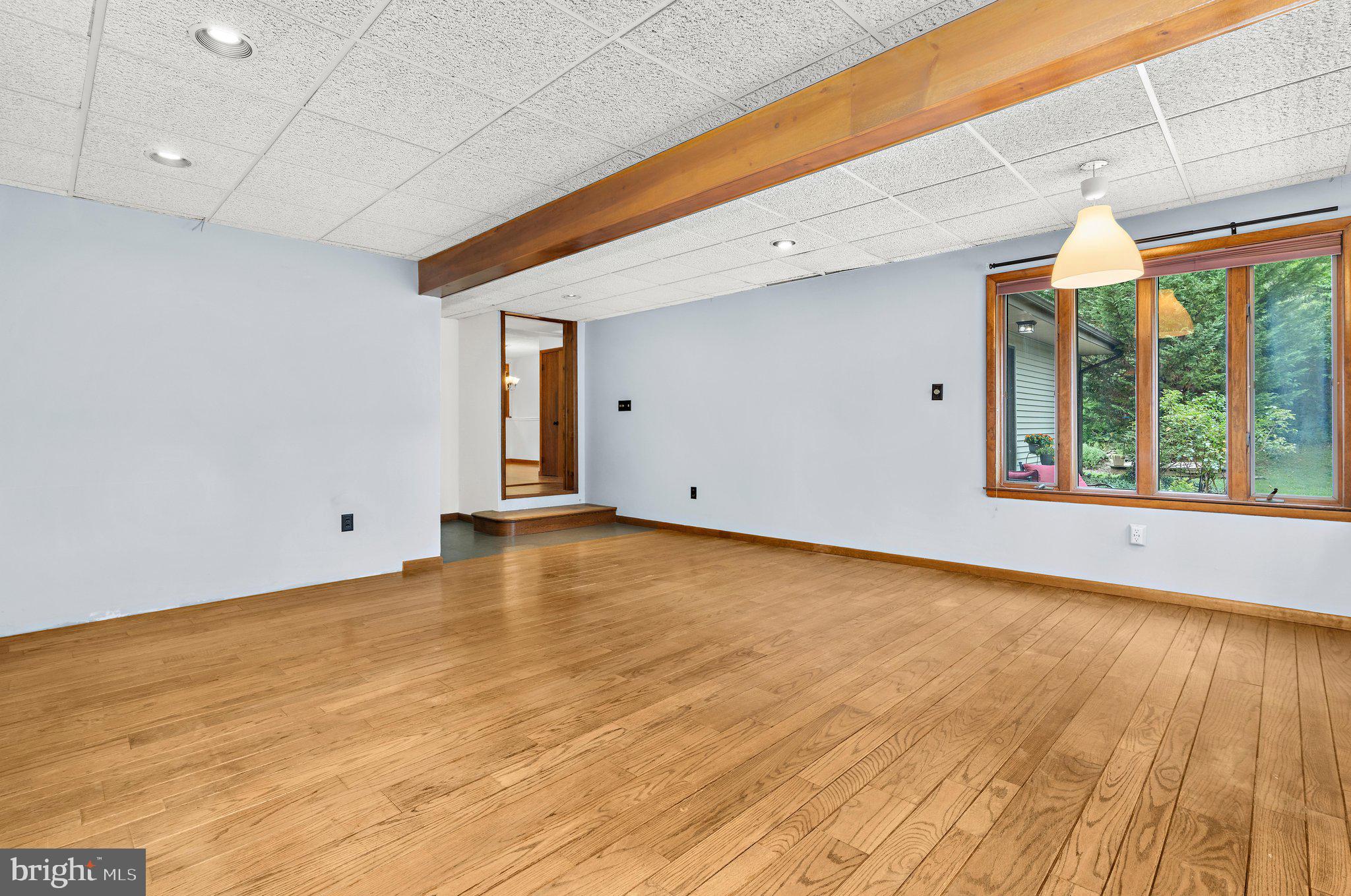 716 Andover Road Linthicum Heights, MD 21090 - Photo 14 of 48 a view of an empty room with wooden floor and a window